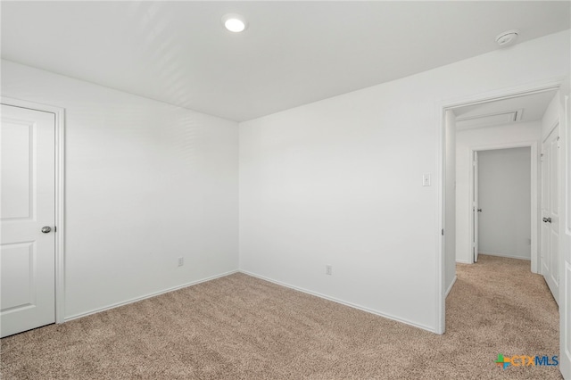 unfurnished room featuring light colored carpet