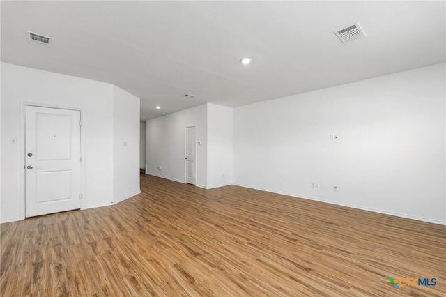 spare room with light hardwood / wood-style flooring