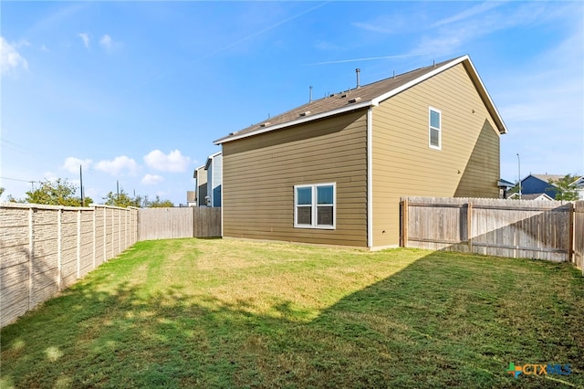 back of house featuring a yard