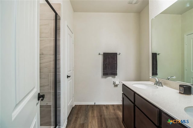 bathroom featuring hardwood / wood-style flooring, vanity, and an enclosed shower