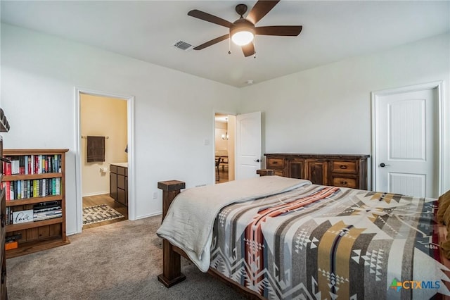 carpeted bedroom with ceiling fan and ensuite bath