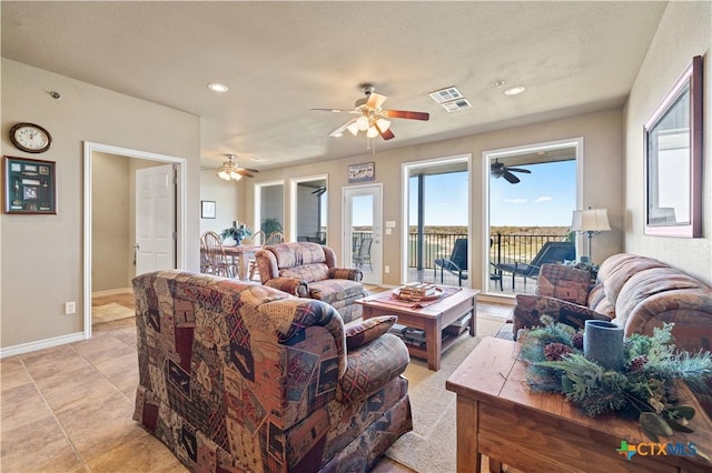 living room with recessed lighting, baseboards, and light tile patterned floors