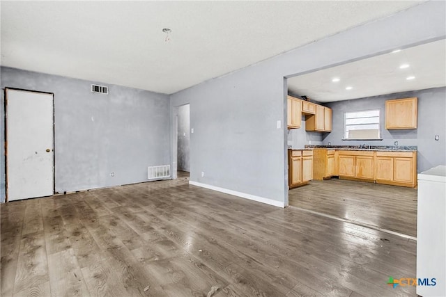 unfurnished living room with wood-type flooring