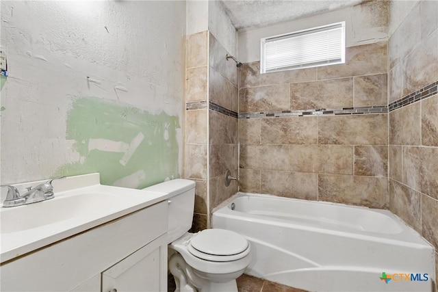 full bathroom featuring vanity, toilet, and tiled shower / bath