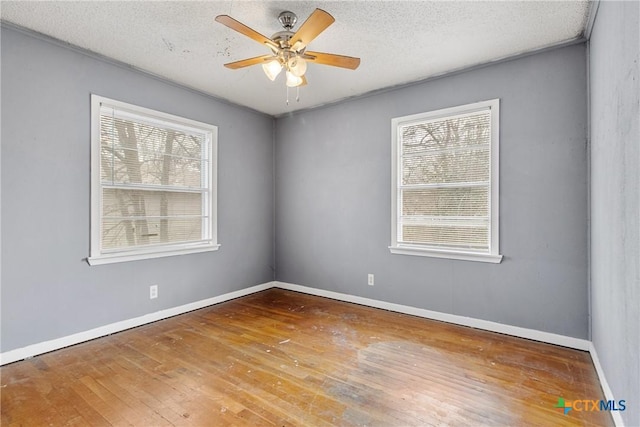 empty room with wood-type flooring, a textured ceiling, and ceiling fan