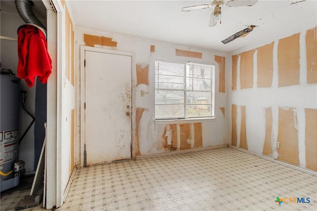 interior space featuring ceiling fan and gas water heater