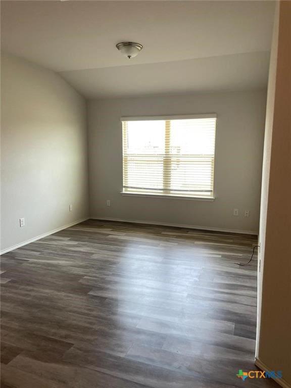 2411 Pintail Loop, Copperas Cove, TX 76522 - empty room with dark wood-type flooring, baseboards, and lofted ceiling