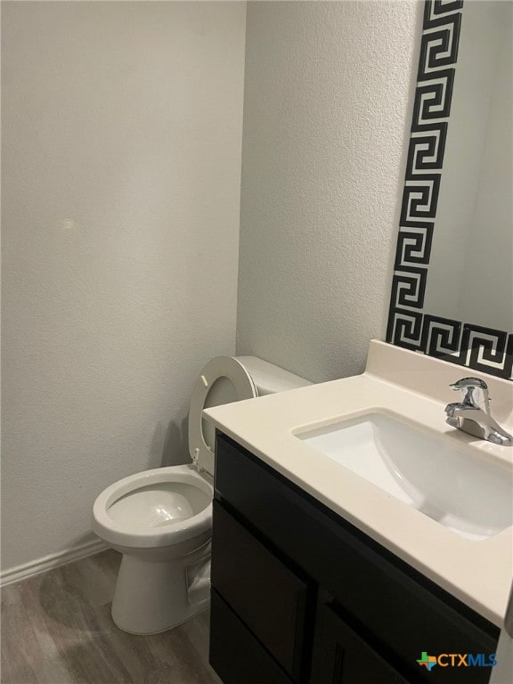 2411 Pintail Loop, Copperas Cove, TX 76522 - half bath with vanity, toilet, a textured wall, and baseboards
