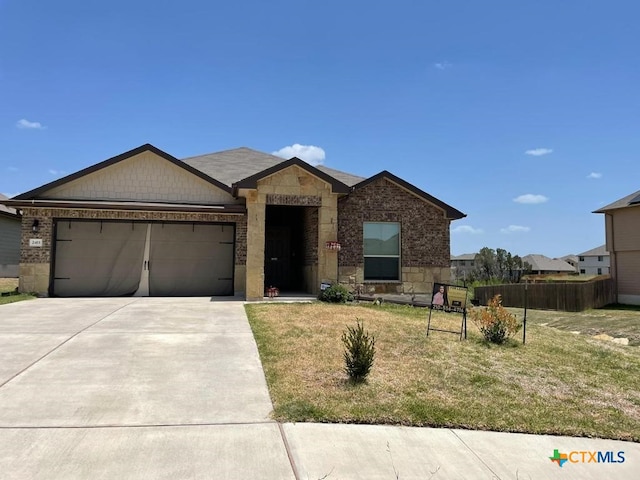 2411 Pintail Loop, Copperas Cove, TX 76522 - ranch-style home with an attached garage, stone siding, and concrete driveway