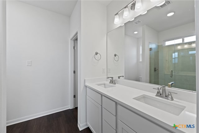 bathroom featuring hardwood / wood-style floors, vanity, toilet, and a shower with shower door