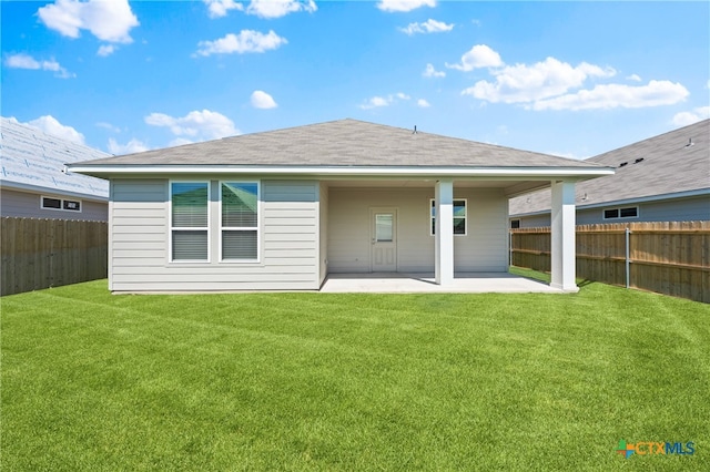 rear view of property with a patio area and a lawn