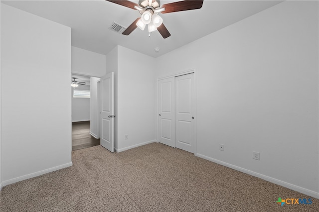 unfurnished bedroom with carpet, a closet, and ceiling fan