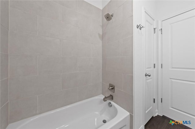 619 Killam Dr, Temple, TX 76502 - bathroom featuring washtub / shower combination and wood finished floors