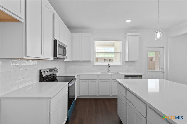 619 Killam Dr, Temple, TX 76502 - kitchen with stainless steel appliances, a sink, light countertops, white cabinetry, and recessed lighting
