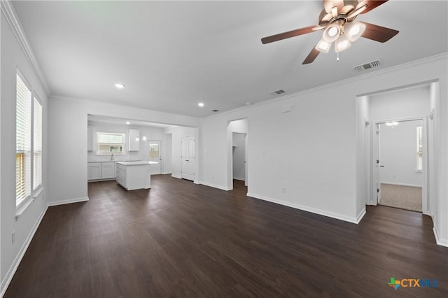 619 Killam Dr, Temple, TX 76502 - unfurnished living room featuring crown molding, dark wood-style floors, a ceiling fan, baseboards, and recessed lighting