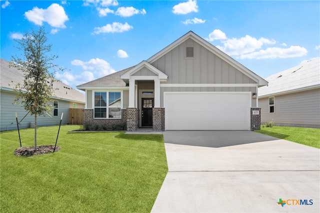 craftsman inspired home featuring a garage and a front lawn