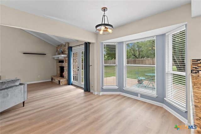 907 Great Oaks Cv, Round Rock, TX 78681 - unfurnished dining area featuring light wood-type flooring and a stone fireplace