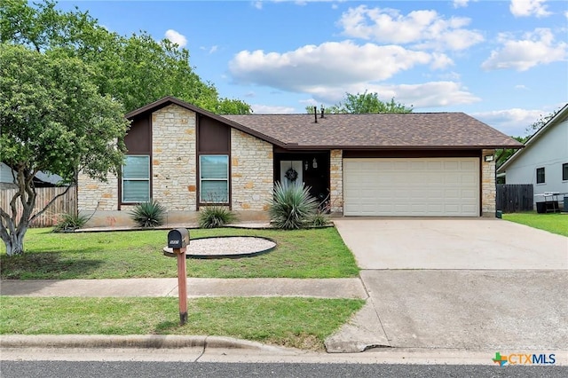 907 Great Oaks Cv, Round Rock, TX 78681 - mid-century modern home featuring stone siding, a garage, concrete driveway, and roof with shingles