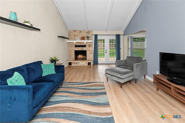 907 Great Oaks Cv, Round Rock, TX 78681 - living area featuring french doors, a fireplace, and wood finished floors