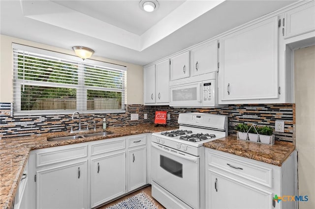 907 Great Oaks Cv, Round Rock, TX 78681 - kitchen with white appliances, plenty of natural light, tasteful backsplash, and white cabinets