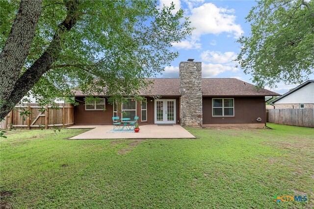 907 Great Oaks Cv, Round Rock, TX 78681 - back of property featuring french doors, a chimney, a fenced backyard, a patio, and a shingled roof