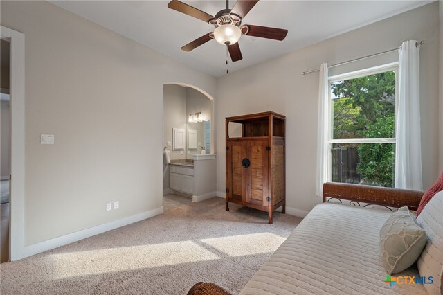 916 Dream Catcher Dr, Leander, TX 78641 - bedroom featuring light colored carpet, arched walkways, baseboards, ensuite bath, and a ceiling fan