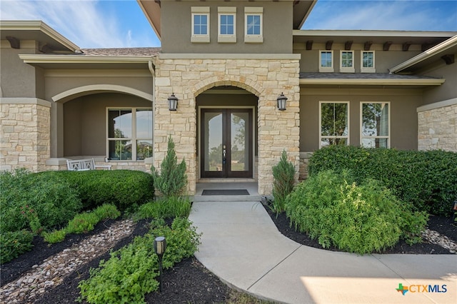 916 Dream Catcher Dr, Leander, TX 78641 - entrance to property featuring stucco siding, stone siding, and french doors