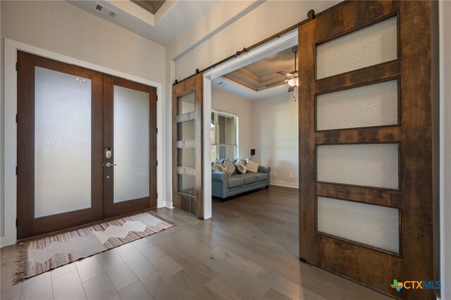 916 Dream Catcher Dr, Leander, TX 78641 - entrance foyer with french doors, a barn door, ceiling fan, wood finished floors, and baseboards