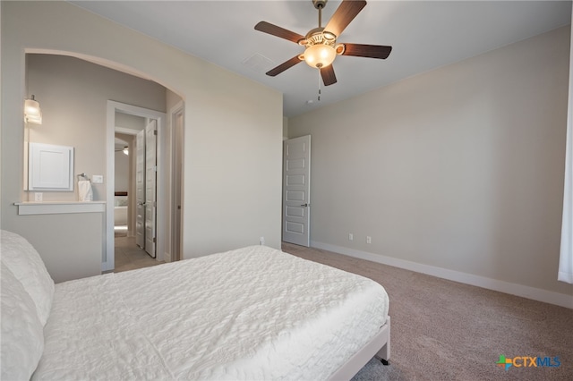 916 Dream Catcher Dr, Leander, TX 78641 - carpeted bedroom featuring baseboards, arched walkways, a ceiling fan, and connected bathroom
