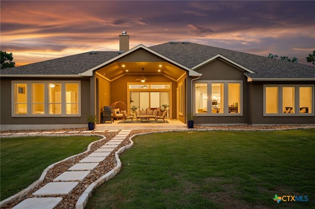 916 Dream Catcher Dr, Leander, TX 78641 - back of house at dusk featuring a patio, a yard, ceiling fan, and a shingled roof