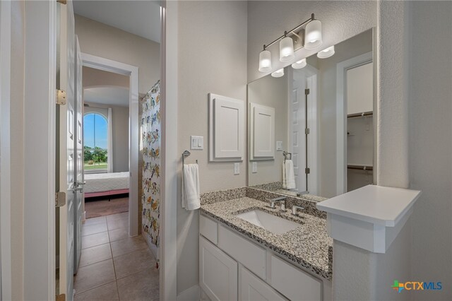 916 Dream Catcher Dr, Leander, TX 78641 - bathroom featuring tile patterned floors, baseboards, and vanity