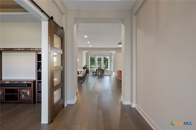 916 Dream Catcher Dr, Leander, TX 78641 - hall featuring a barn door, dark wood finished floors, baseboards, recessed lighting, and built in features