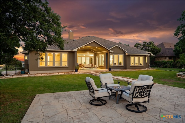 916 Dream Catcher Dr, Leander, TX 78641 - back of house at dusk with a patio and stucco siding