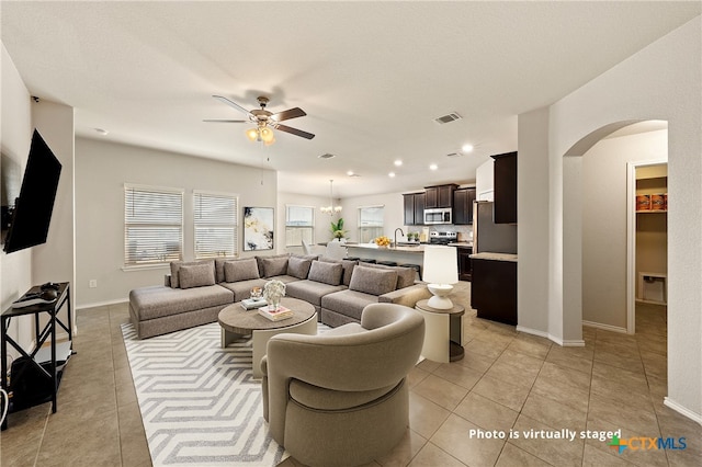 living room with light tile patterned flooring, sink, and ceiling fan