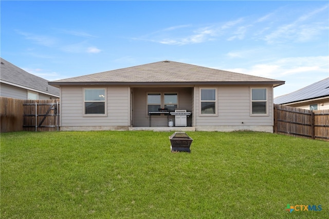 back of house featuring a patio area and a yard