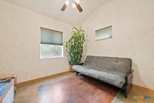 living area featuring lofted ceiling and ceiling fan