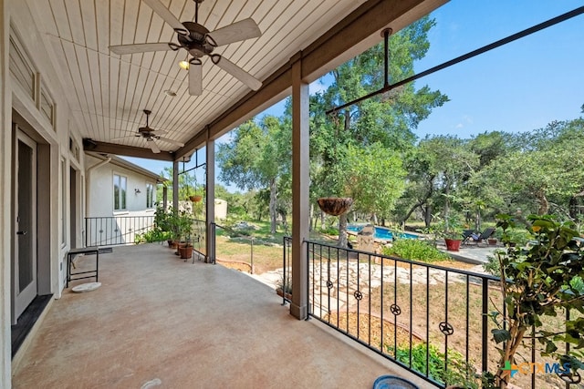 view of patio / terrace with a balcony and ceiling fan