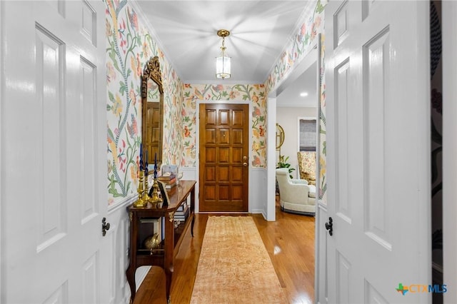 407 Pasadena Dr, Victoria, TX 77904 - foyer with wallpapered walls, light wood-type flooring, and ornamental molding