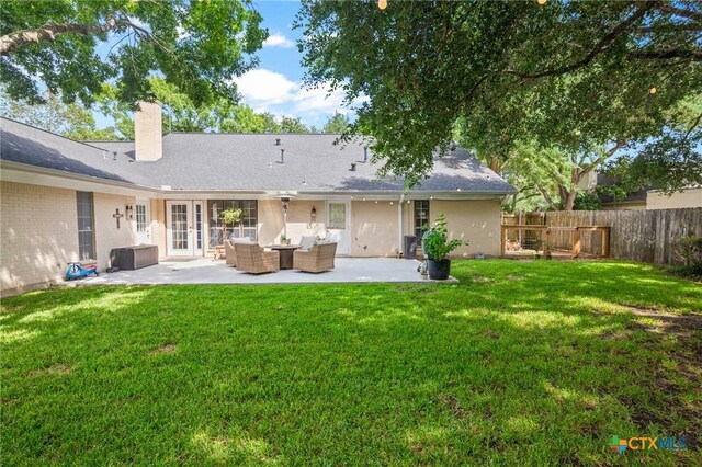 407 Pasadena Dr, Victoria, TX 77904 - rear view of property featuring a patio area, a chimney, outdoor lounge area, and brick siding