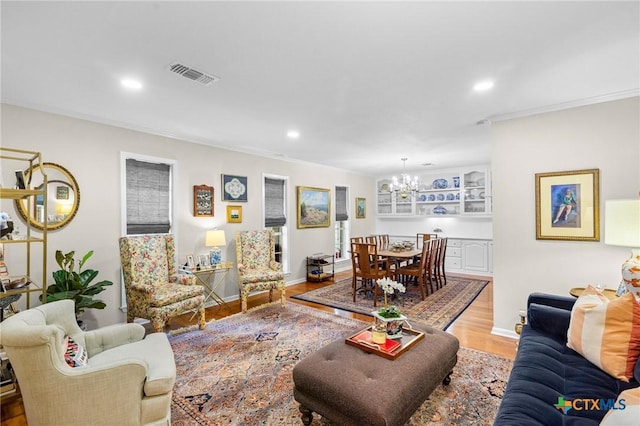 407 Pasadena Dr, Victoria, TX 77904 - living area featuring a chandelier, wood finished floors, recessed lighting, crown molding, and baseboards