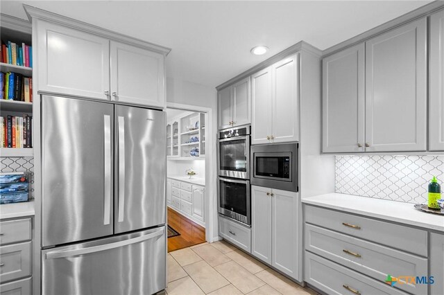 407 Pasadena Dr, Victoria, TX 77904 - kitchen featuring appliances with stainless steel finishes, gray cabinetry, light countertops, backsplash, and recessed lighting