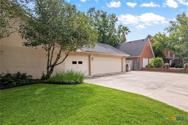407 Pasadena Dr, Victoria, TX 77904 - view of front of home with concrete driveway, an attached garage, and brick siding
