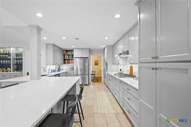 407 Pasadena Dr, Victoria, TX 77904 - kitchen with appliances with stainless steel finishes, open shelves, backsplash, recessed lighting, and light tile patterned floors