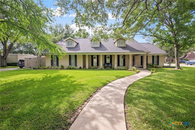 407 Pasadena Dr, Victoria, TX 77904 - cape cod house with covered porch, a front lawn, stucco siding, and roof with shingles