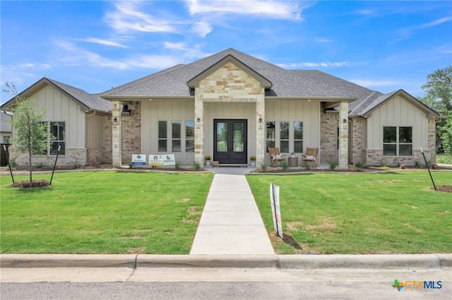 1586 Bosque Lago Dr, Belton, TX 76513 - view of front of property featuring french doors, board and batten siding, roof with shingles, and a front yard