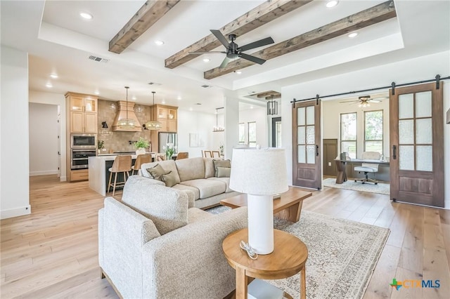 1586 Bosque Lago Dr, Belton, TX 76513 - living area with a barn door, light wood-type flooring, a ceiling fan, beam ceiling, and recessed lighting