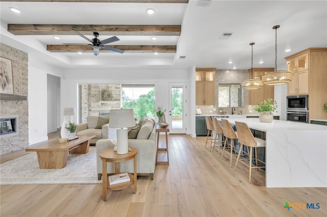 1586 Bosque Lago Dr, Belton, TX 76513 - living area featuring light wood-style flooring, ceiling fan, beam ceiling, recessed lighting, and a stone fireplace