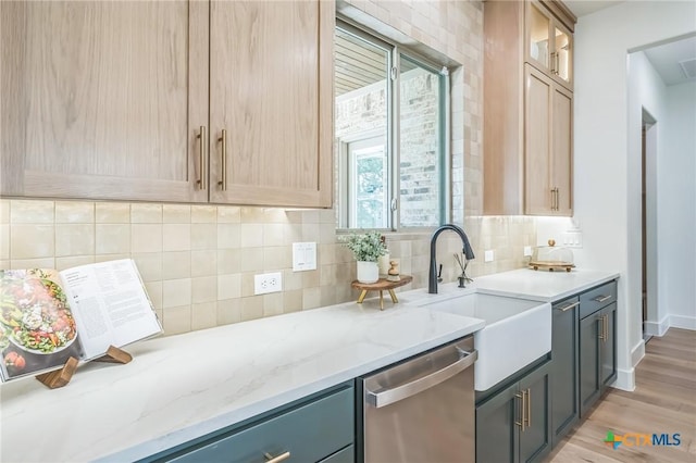 1586 Bosque Lago Dr, Belton, TX 76513 - kitchen with stainless steel dishwasher, decorative backsplash, a sink, light stone countertops, and light wood-style floors