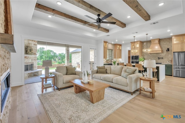 1586 Bosque Lago Dr, Belton, TX 76513 - living area featuring a fireplace, plenty of natural light, ceiling fan, light wood-type flooring, and beam ceiling