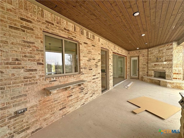 view of patio / terrace featuring an outdoor stone fireplace